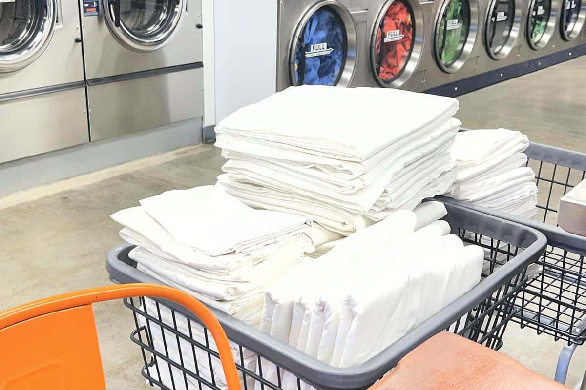 Folded commercial linens at a laundromat