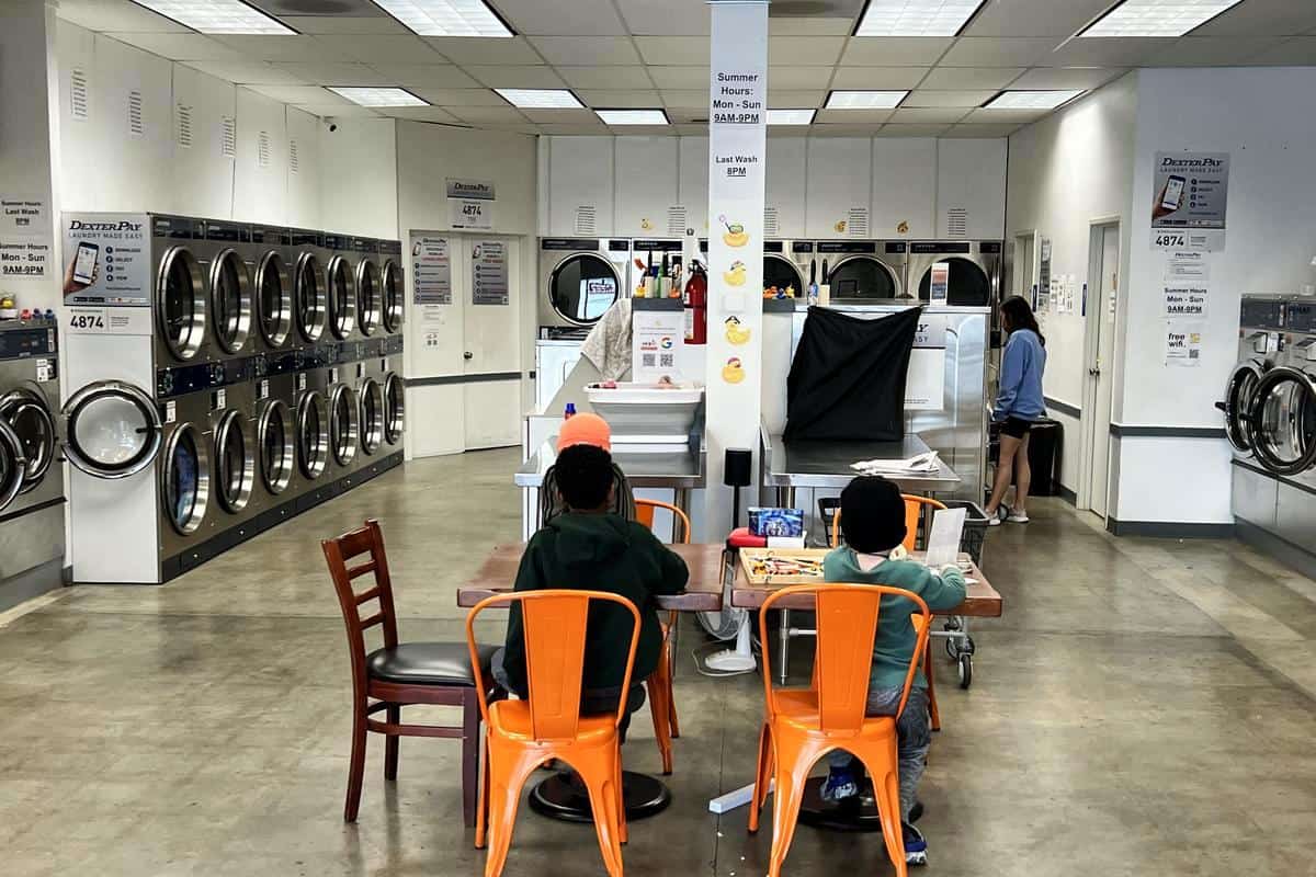 Children coloring at a laundromat cafe table